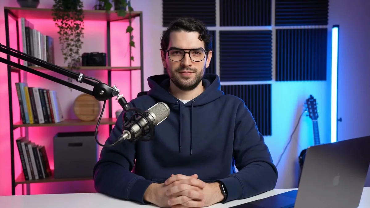 Jaime's HeyGen Avatar V presenter seated at a microphone in a pink and blue studio